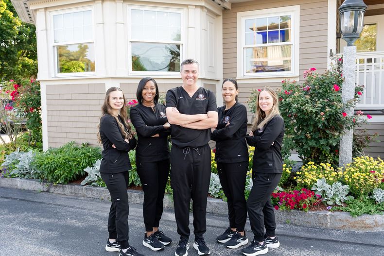 Dr. Russell Mann and the Mann Family Dental team outside their office in Manchester, NH
