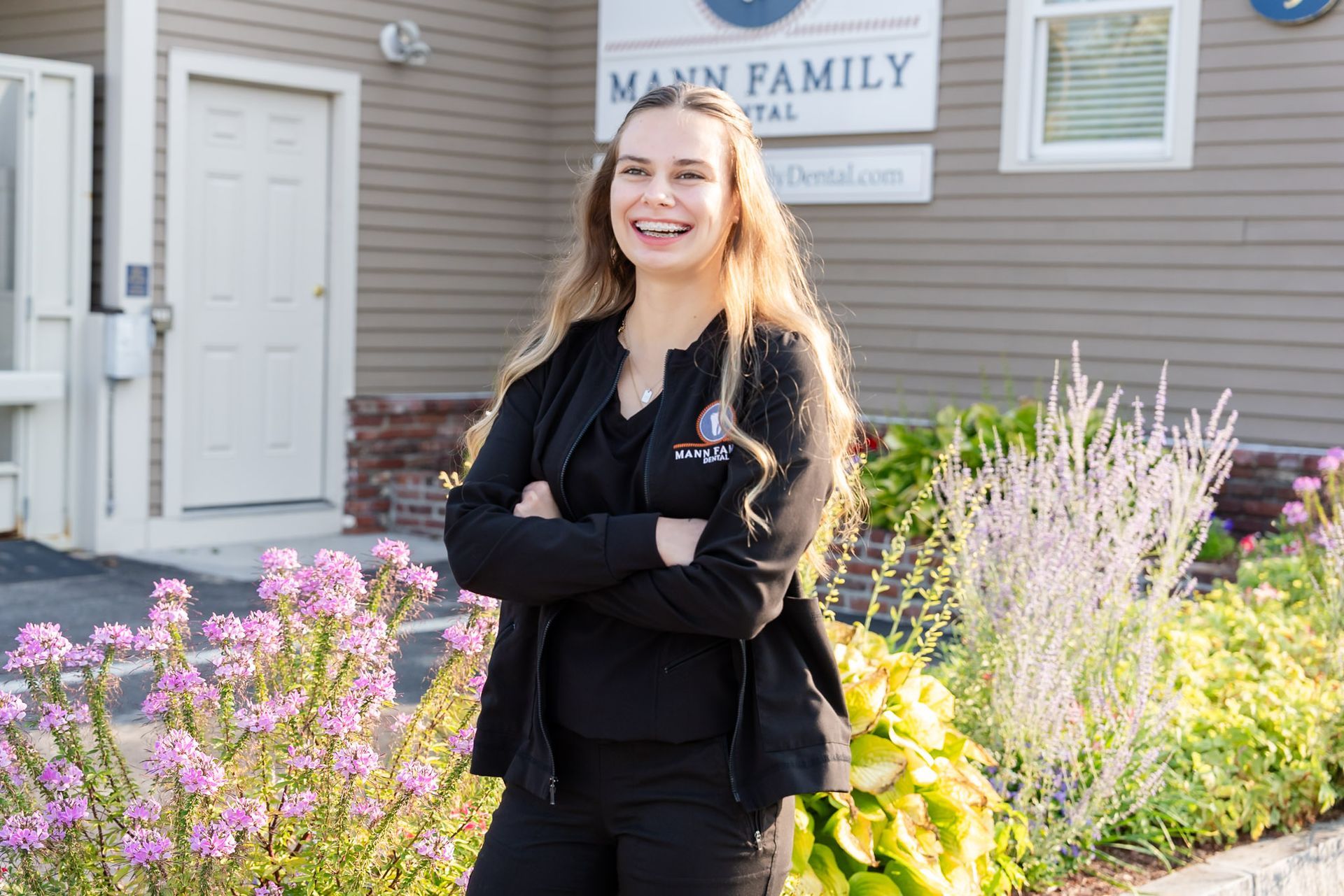Front desk team member laughing outside Mann Family Dental