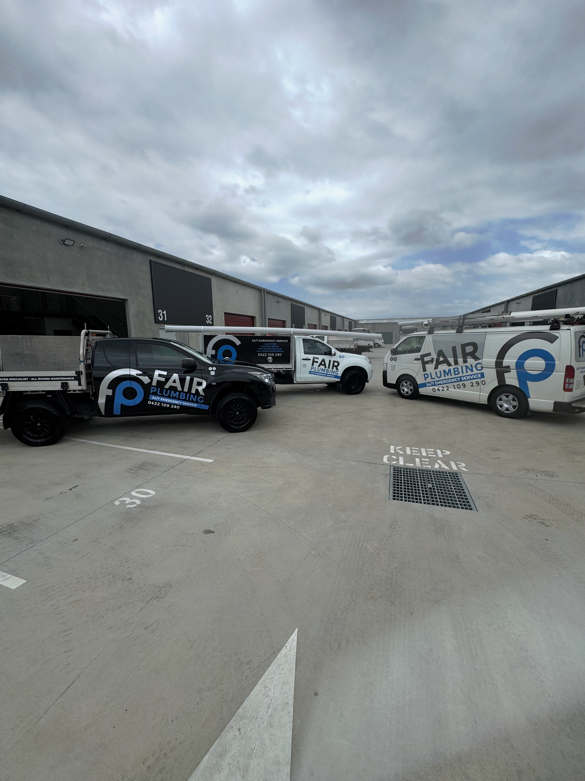 Three Vans Parked on the Driveway— Fair Plumbing In Kembla Grange, NSW