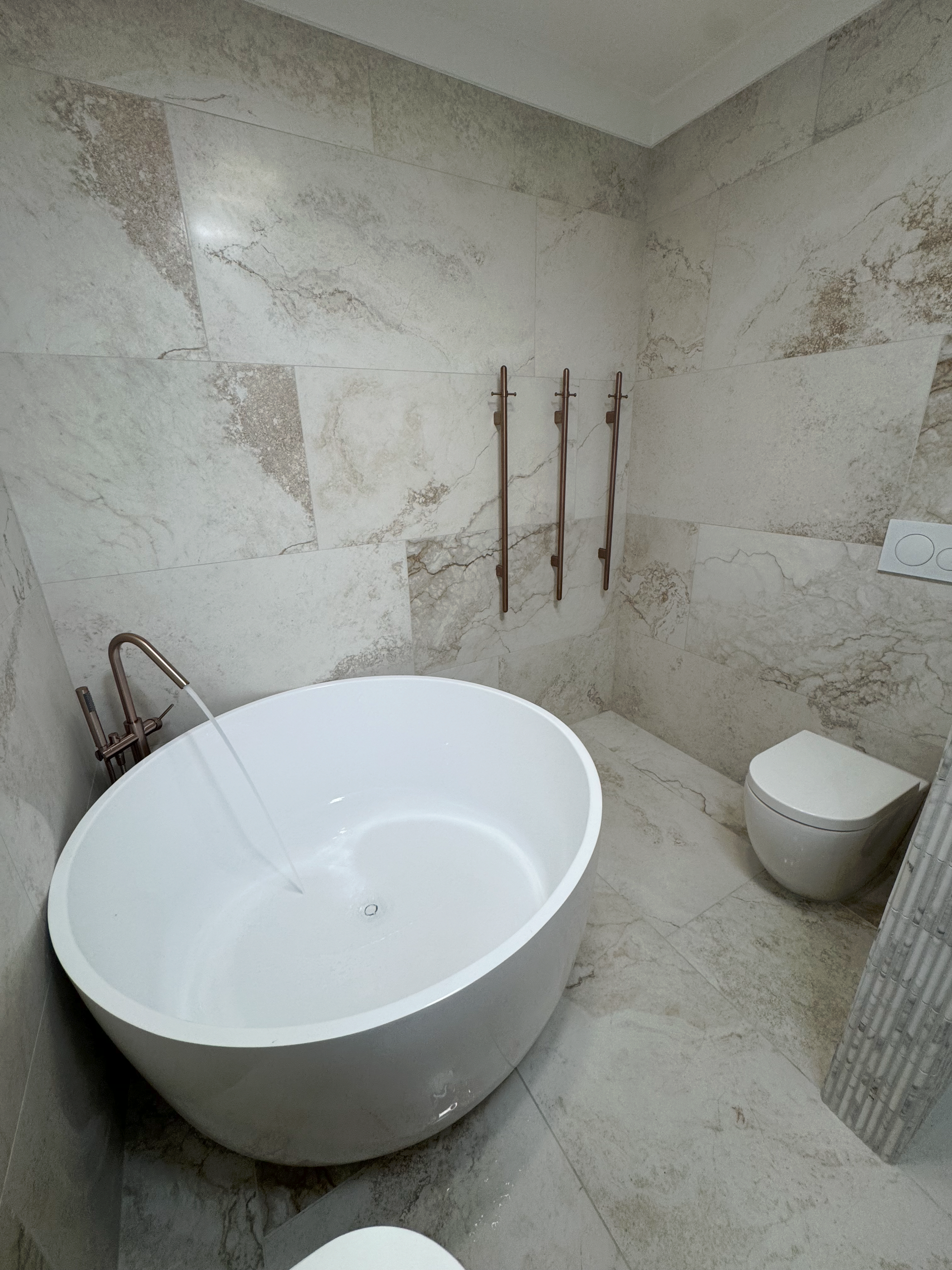 Bathroom with running water into the bath — Fair Plumbing In Kembla Grange, NSW