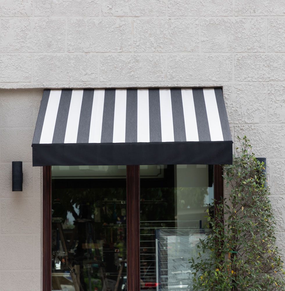 Black And White Awning Over Shop Window — Blinds Installation in Winnellie, NT