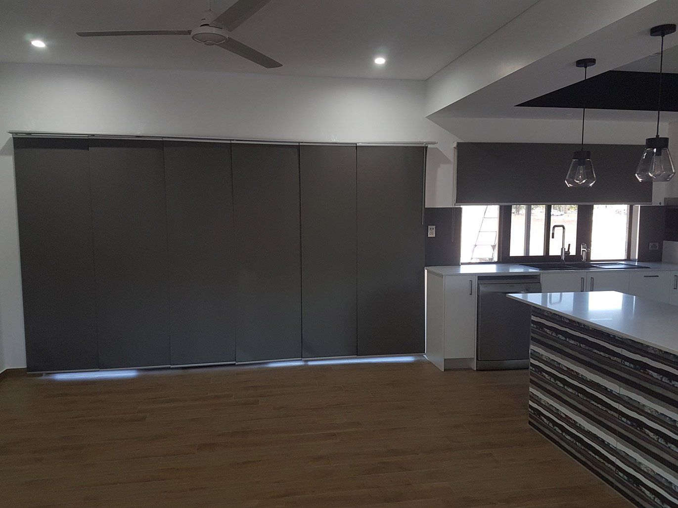 Door With Closed Panel Blinds Near Kitchen — Blinds Installation in Winnellie, NT