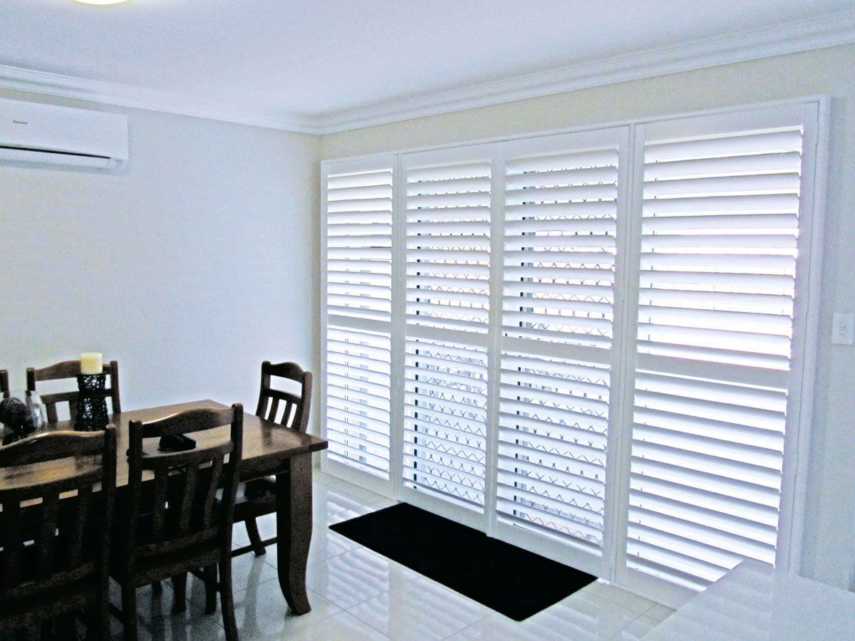 PVC Shutters In Dining room — Blinds Installation in Winnellie, NT