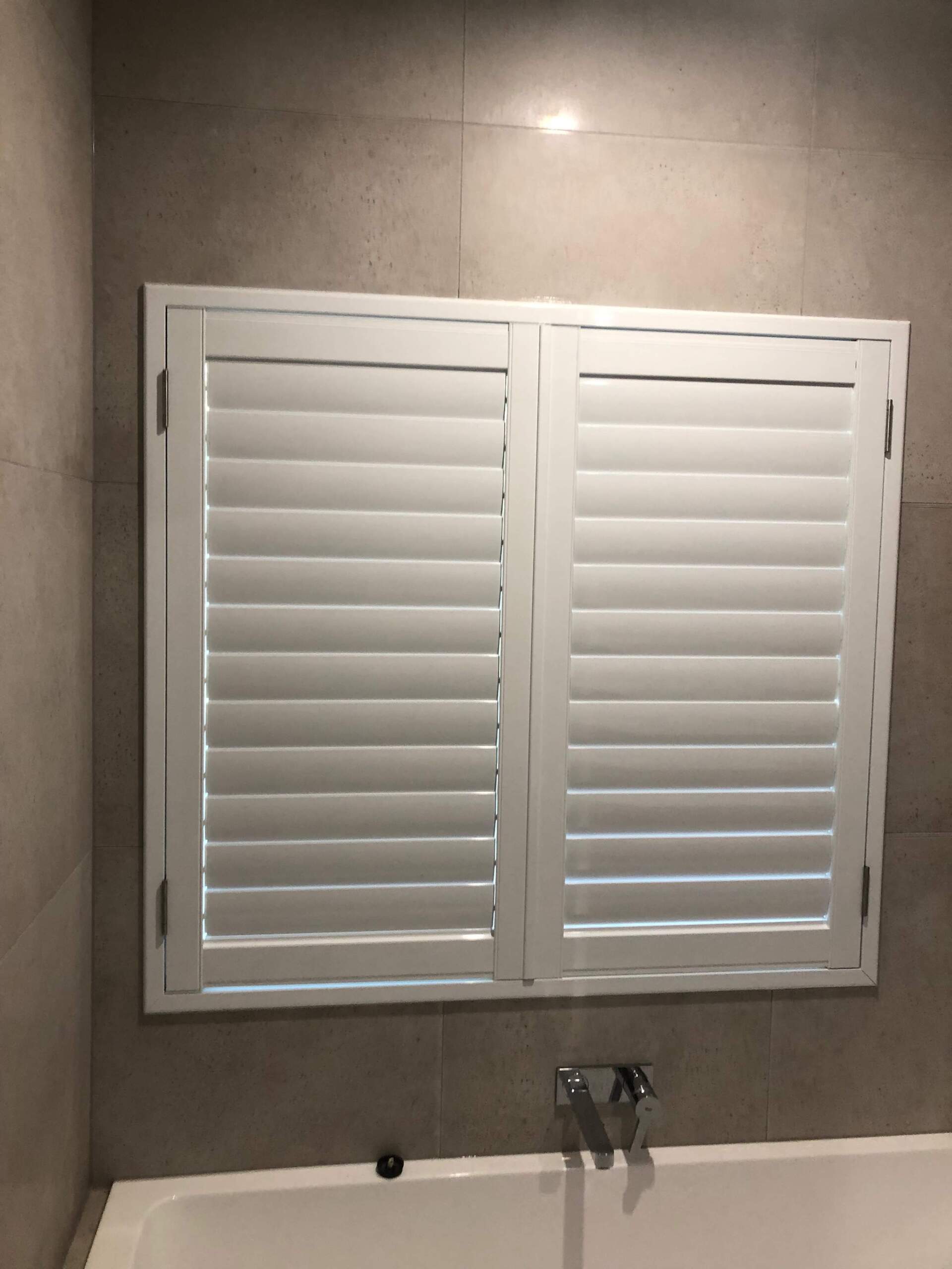 Closed Plantation Shutters In Bathroom — Blinds Installation in Winnellie, NT