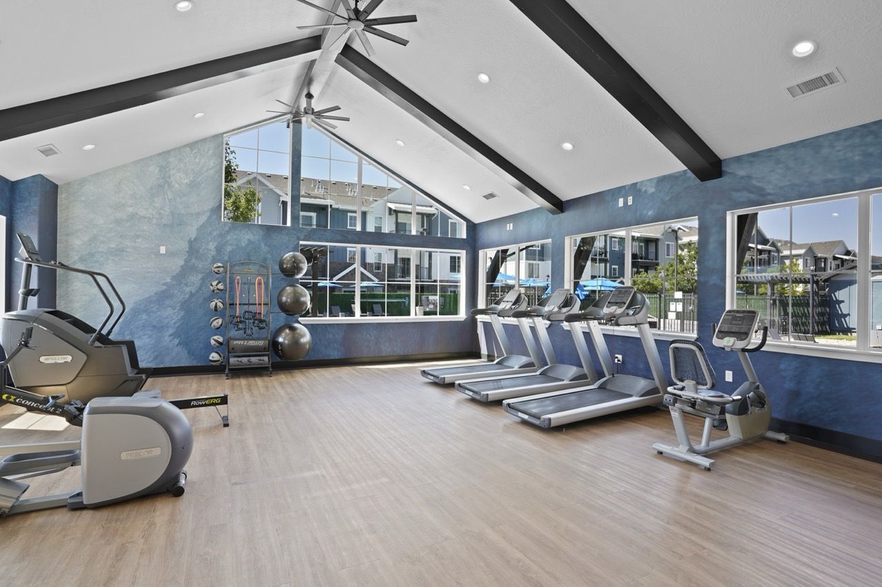 Bright apartment community gym with treadmills, bikes, and weights at Viewpointe—offering apartments for rent near Salt Lake City.