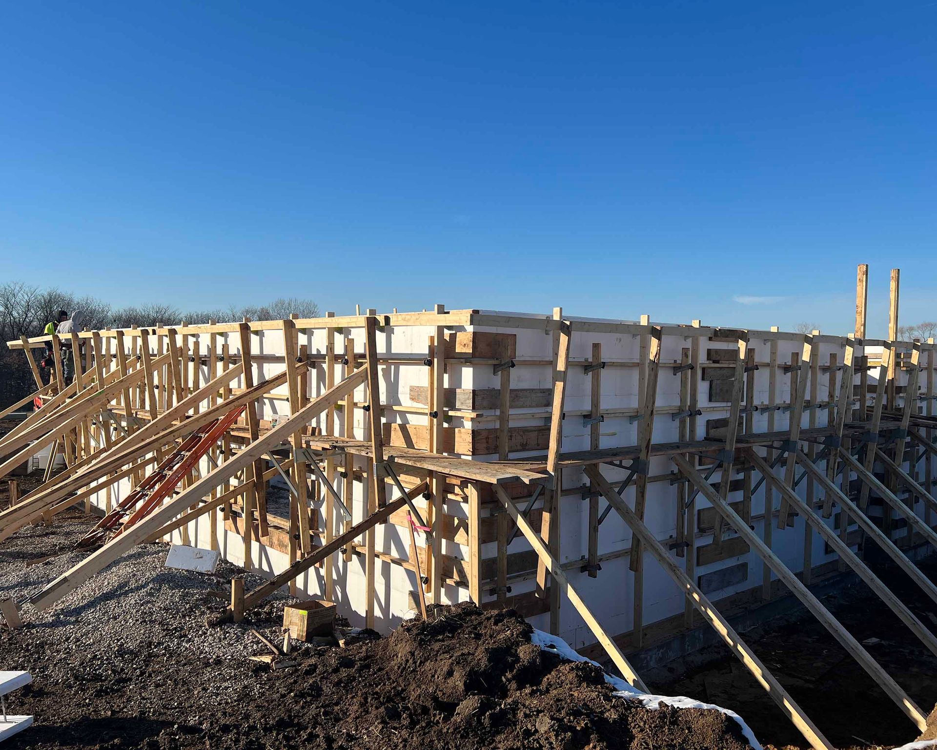 A large building under construction with a blue sky in the background