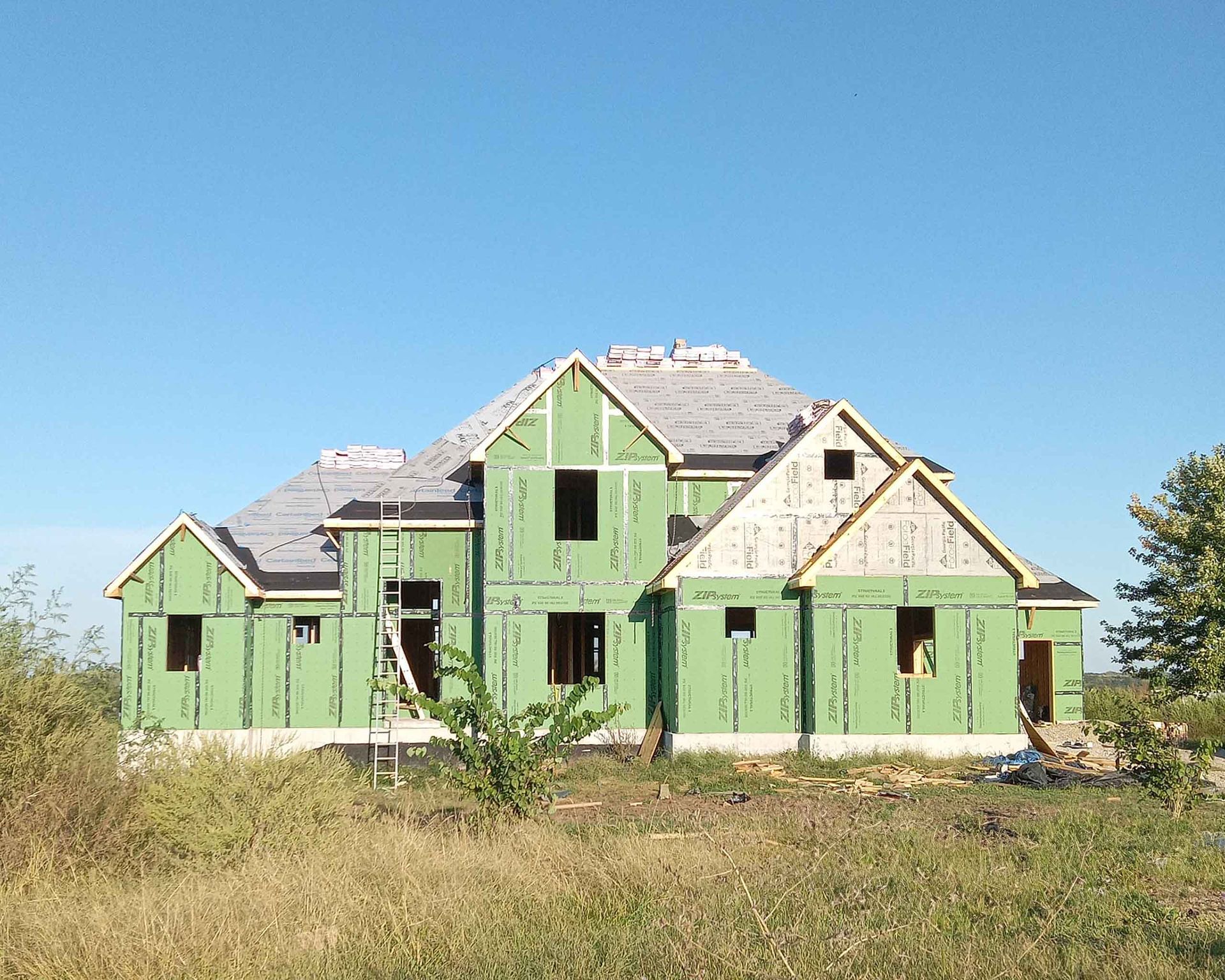 A house that is being built with green siding