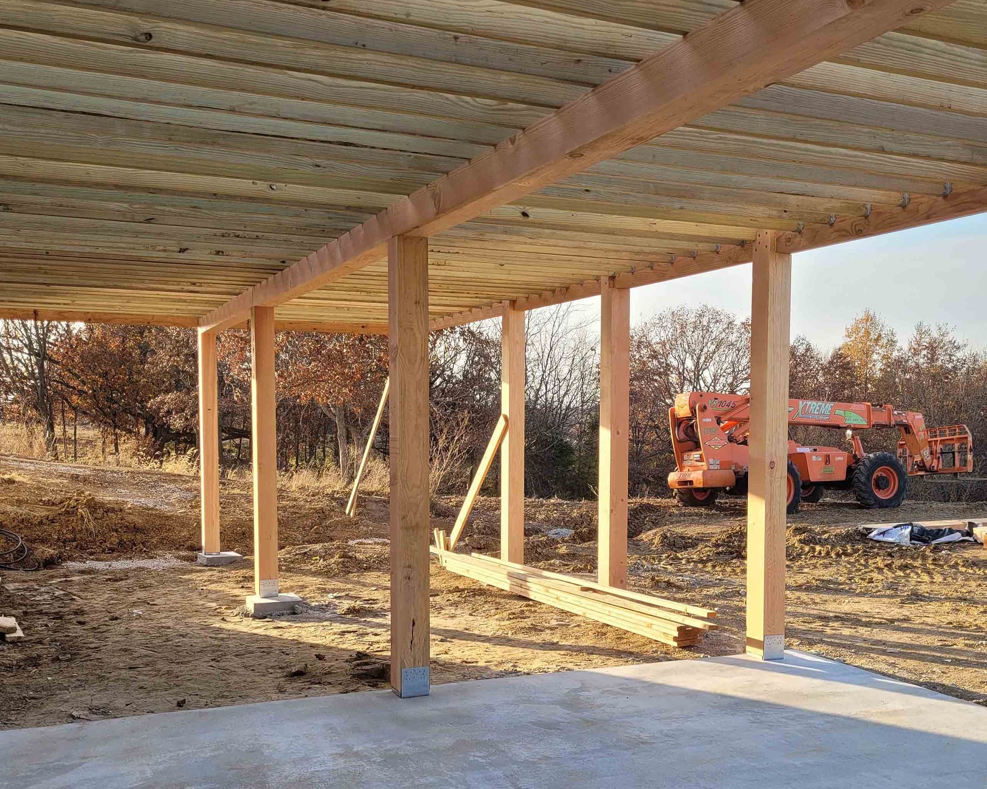 A wooden structure is being built with a crane in the background.
