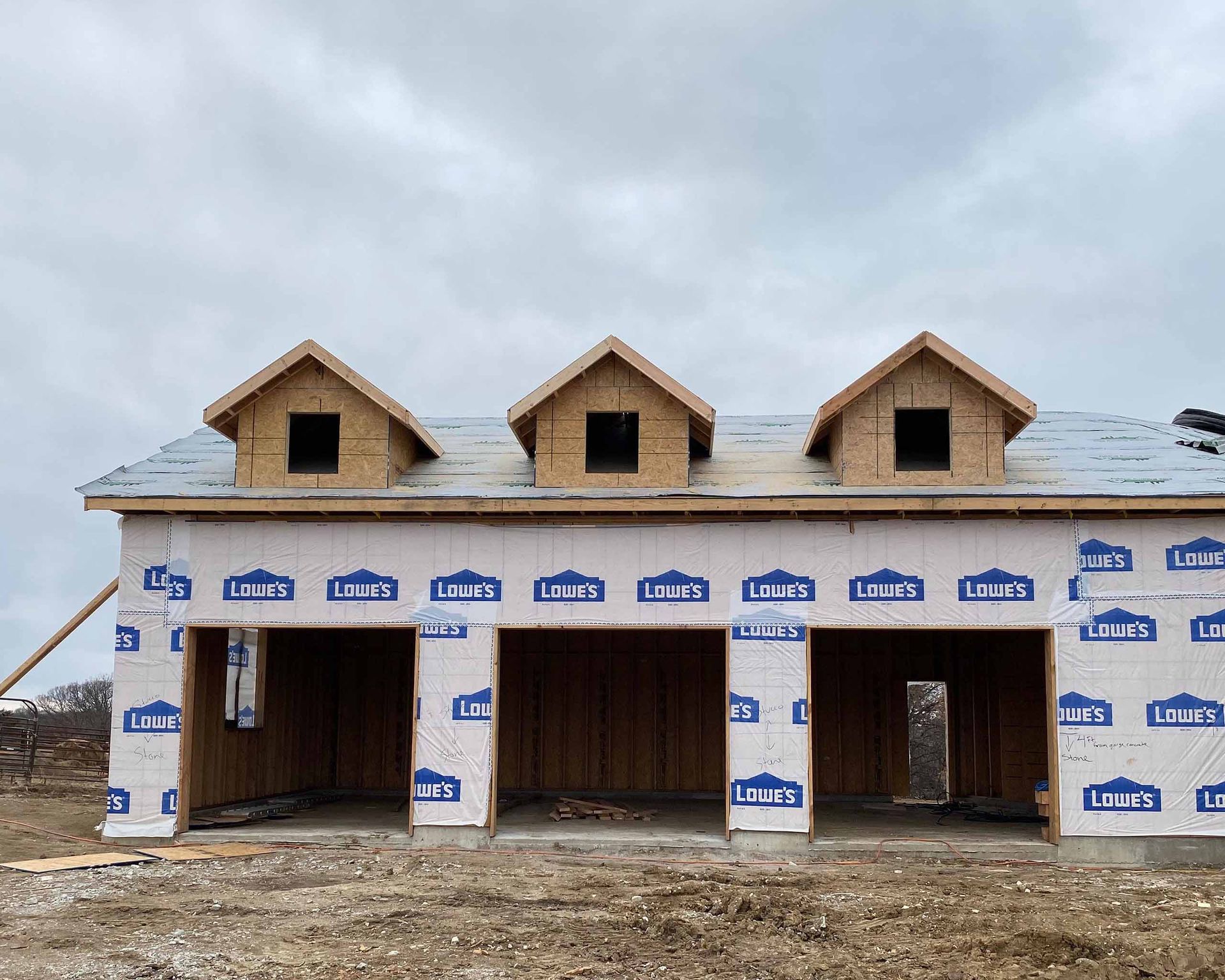 A house is being built with a lot of plywood and roofing.