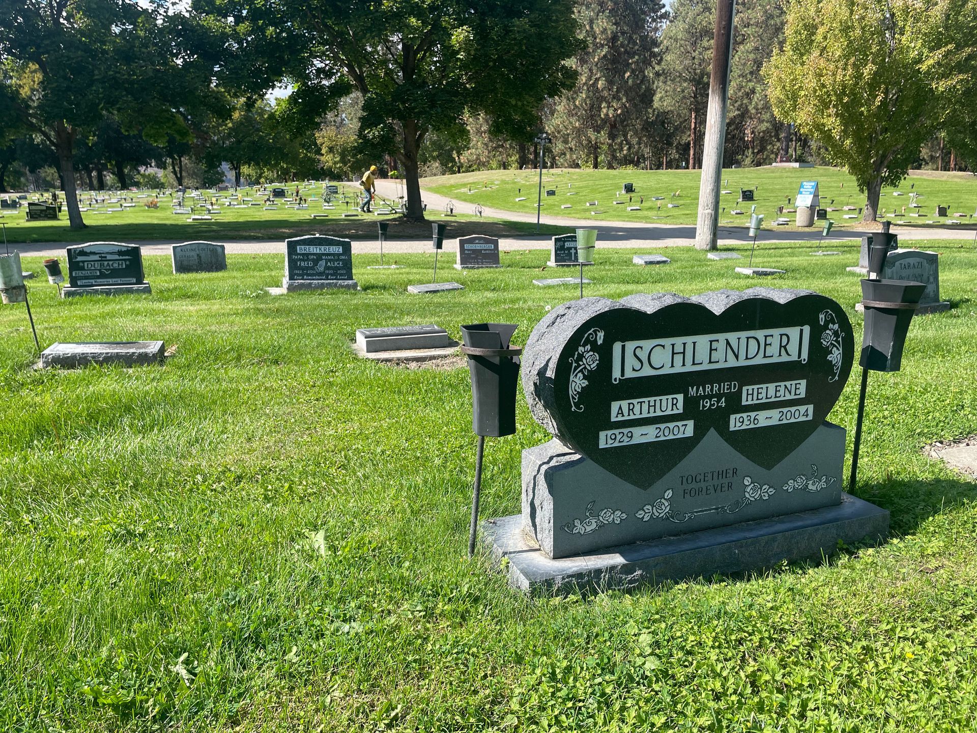 A heart shaped gravestone in a cemetery with the name schlender on it