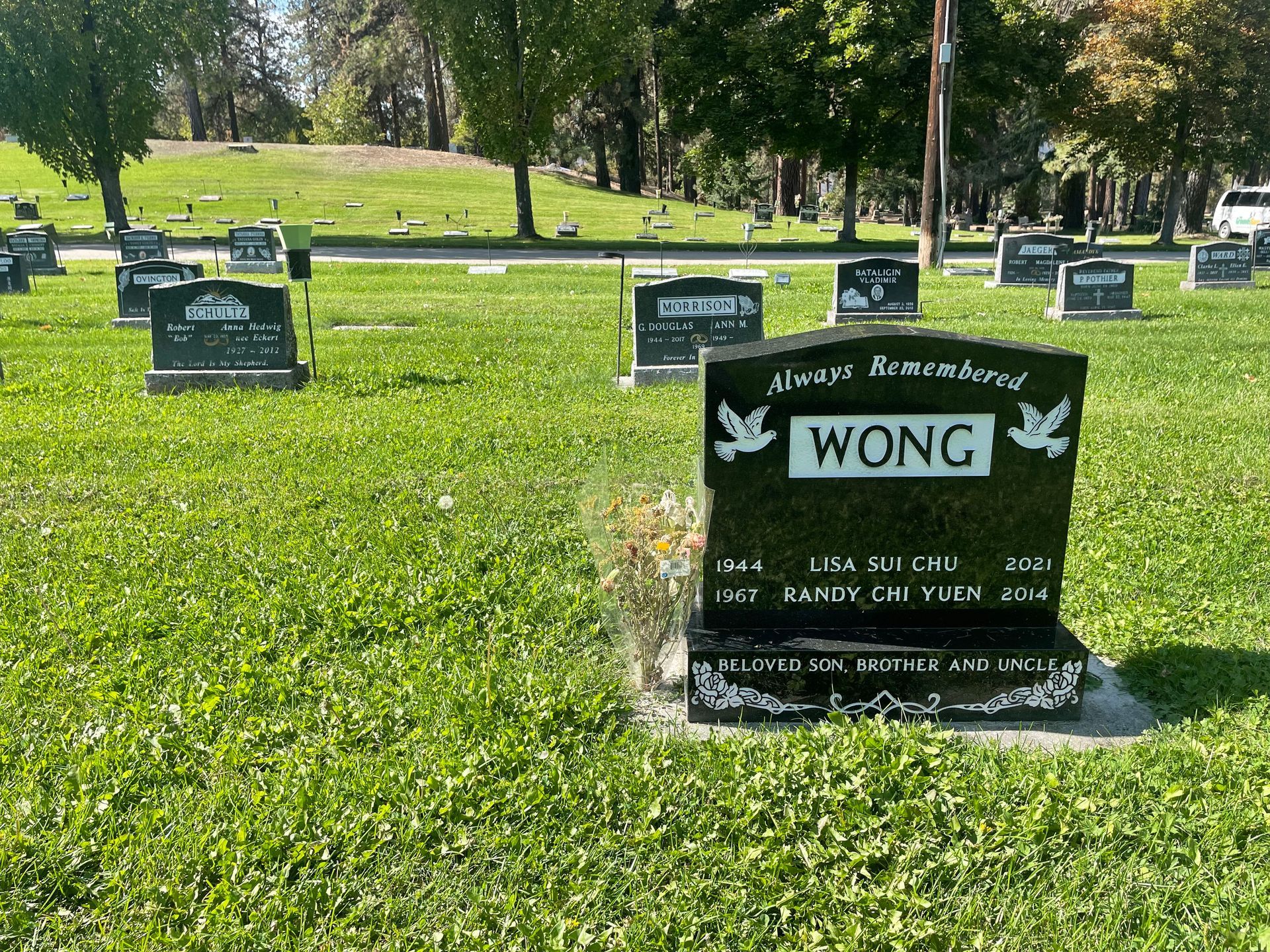A grave in a cemetery with the name wong on it