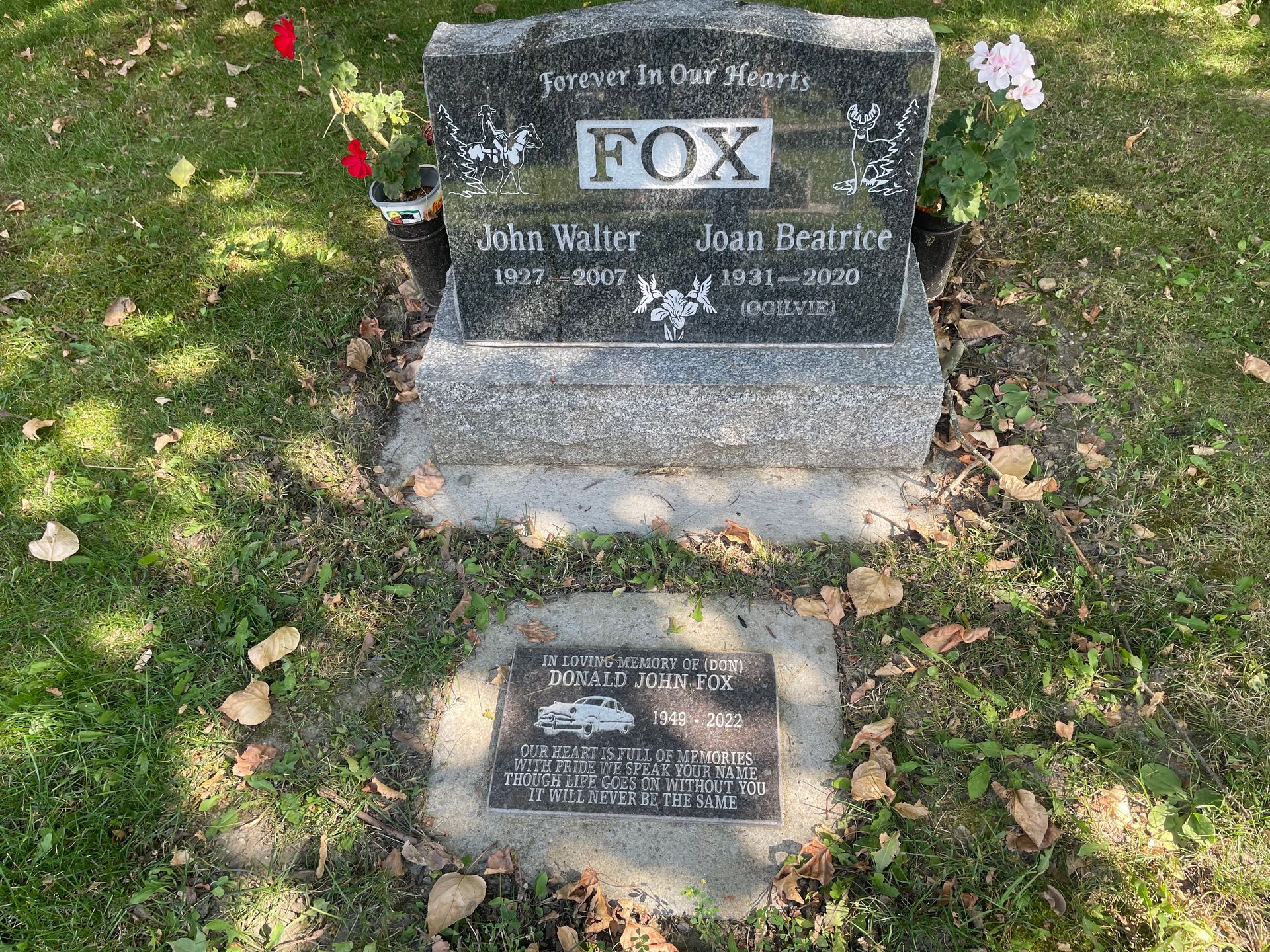 A grave of a man and woman named fox in a cemetery.