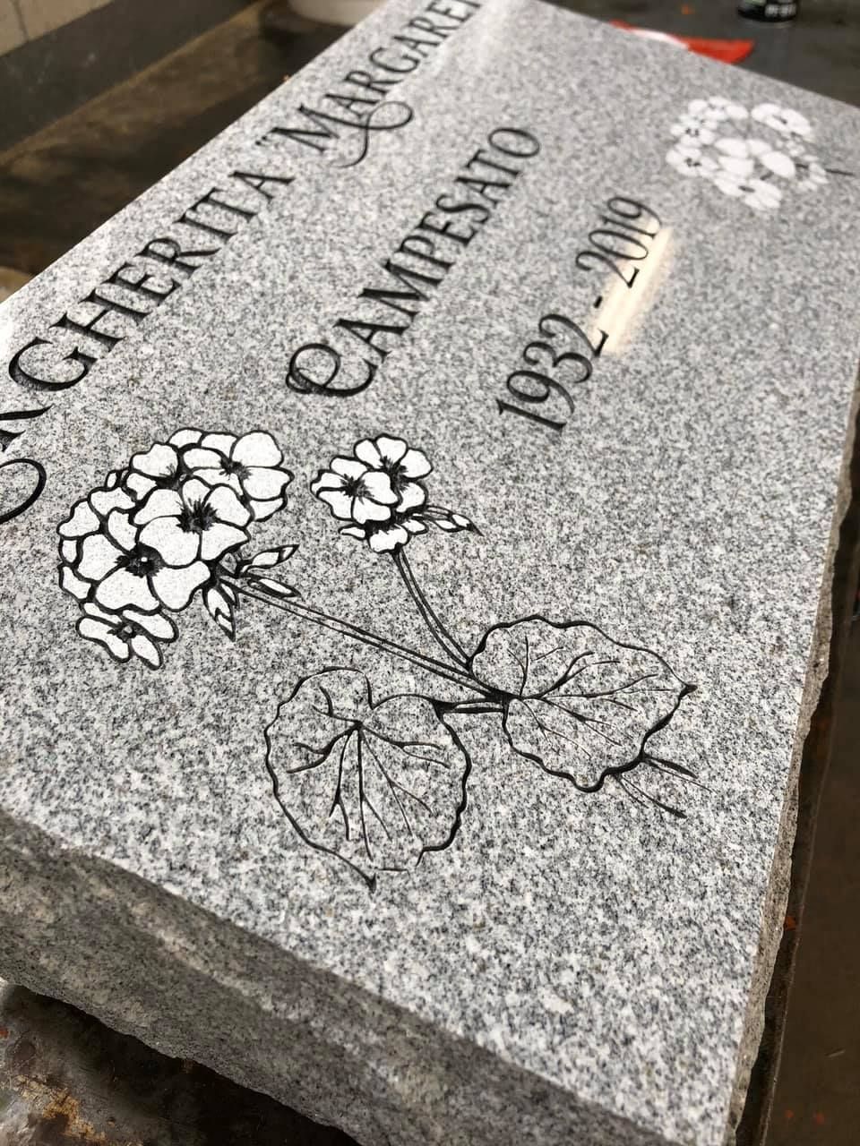 A gravestone with a drawing of flowers on it.