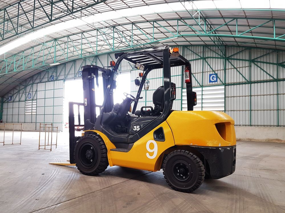 Yellow Forklift in a Warehouse, Viewed From the Side, With a Large Arched Roof Overhead — Lifters Hire in Cambridge, TAS