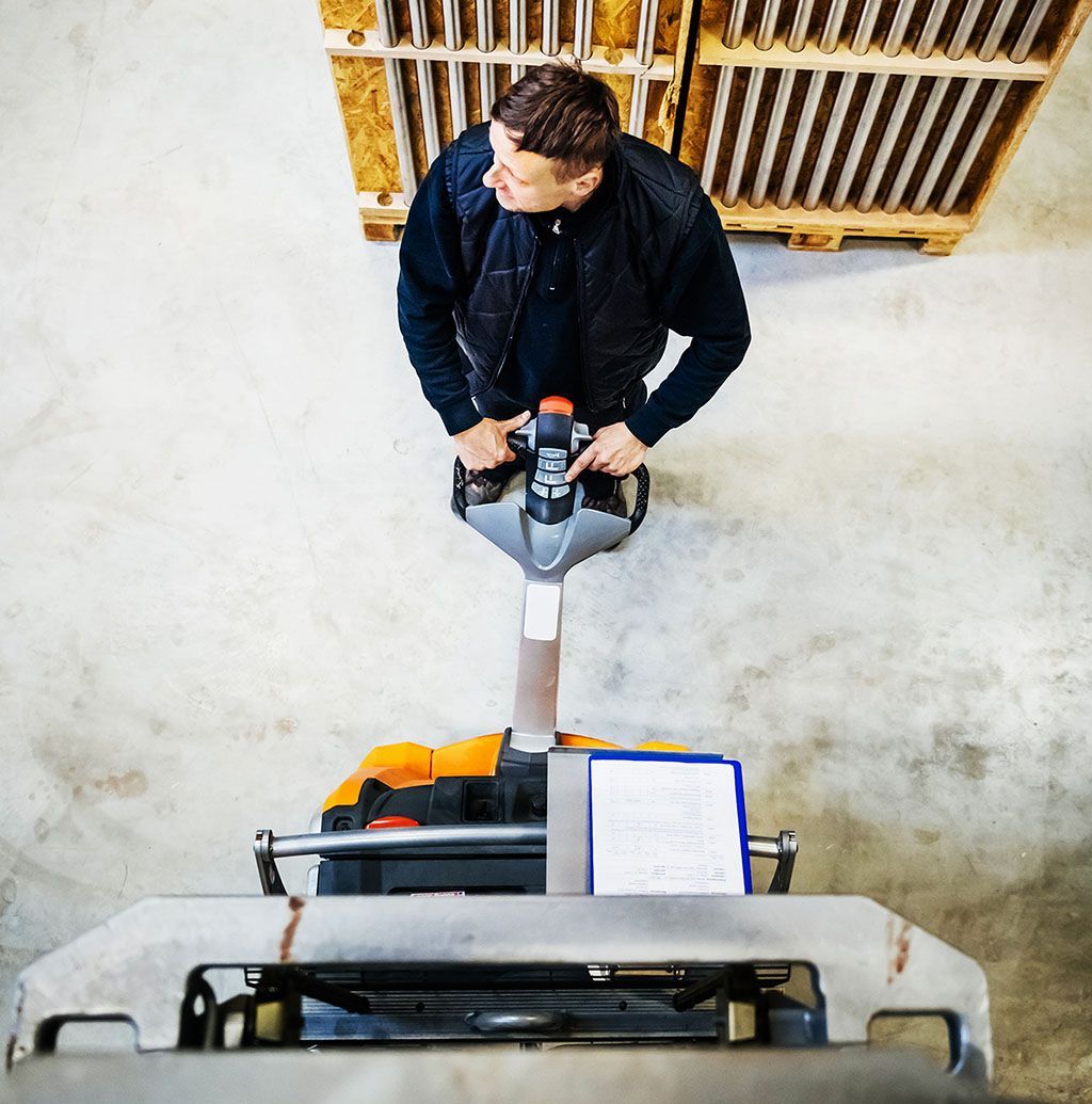 MAN Operating a Floor-cleaning Machine in a Bright Indoor Room — Lifters Hire in Cambridge, TAS