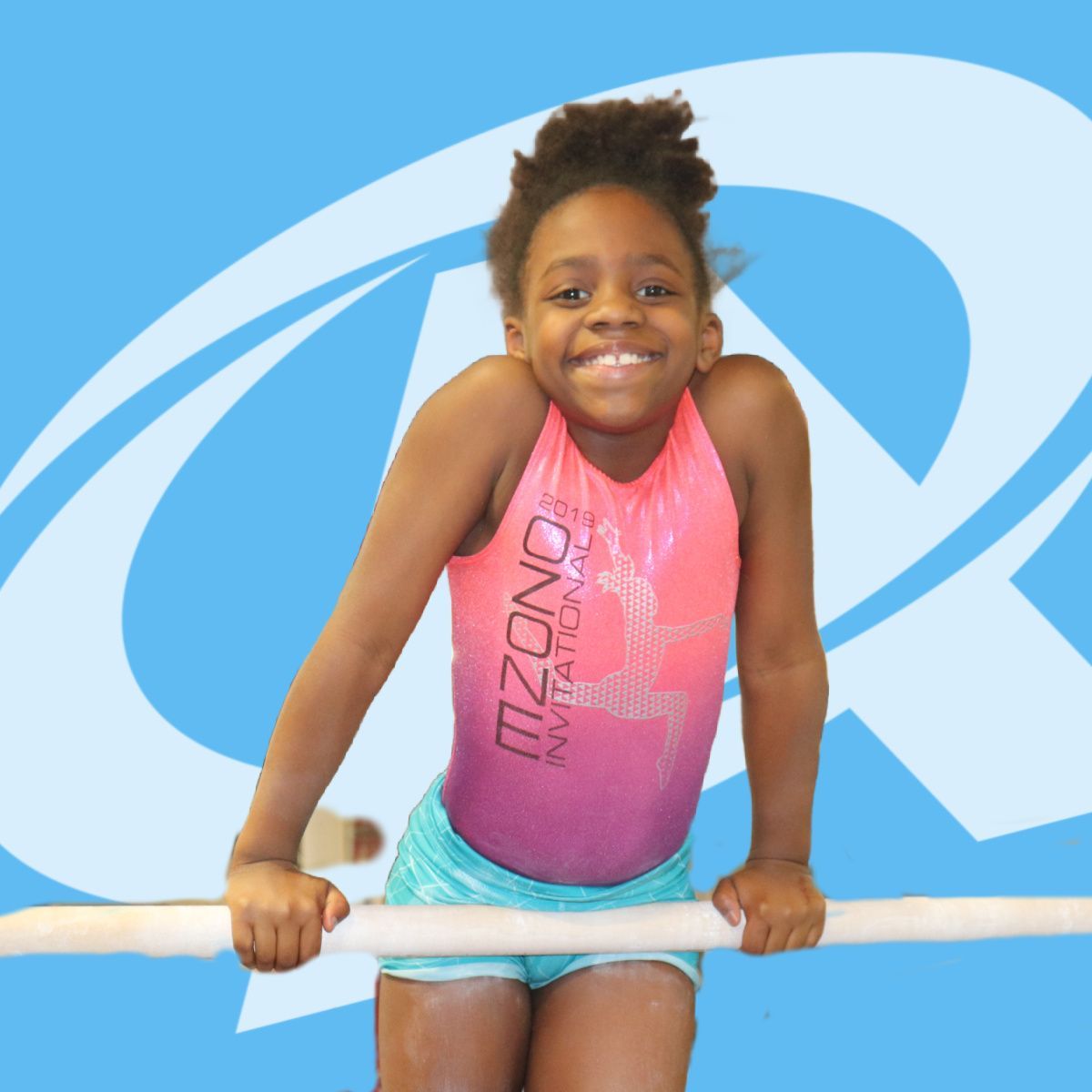 A young girl in a pink leotard that says mzono on it