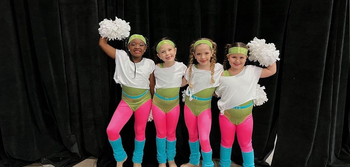 girls in leotards smiling