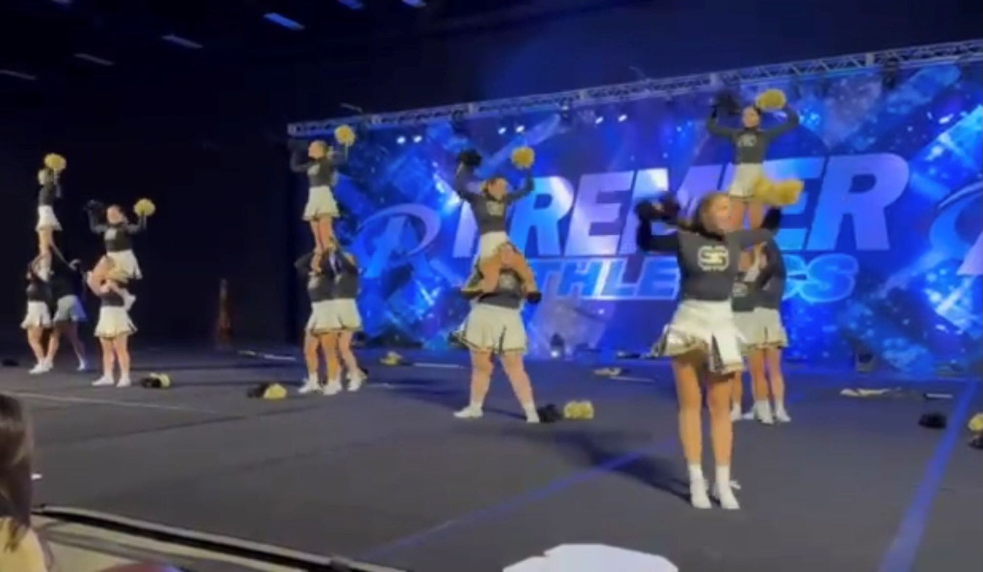 A group of cheerleaders are performing on a stage.