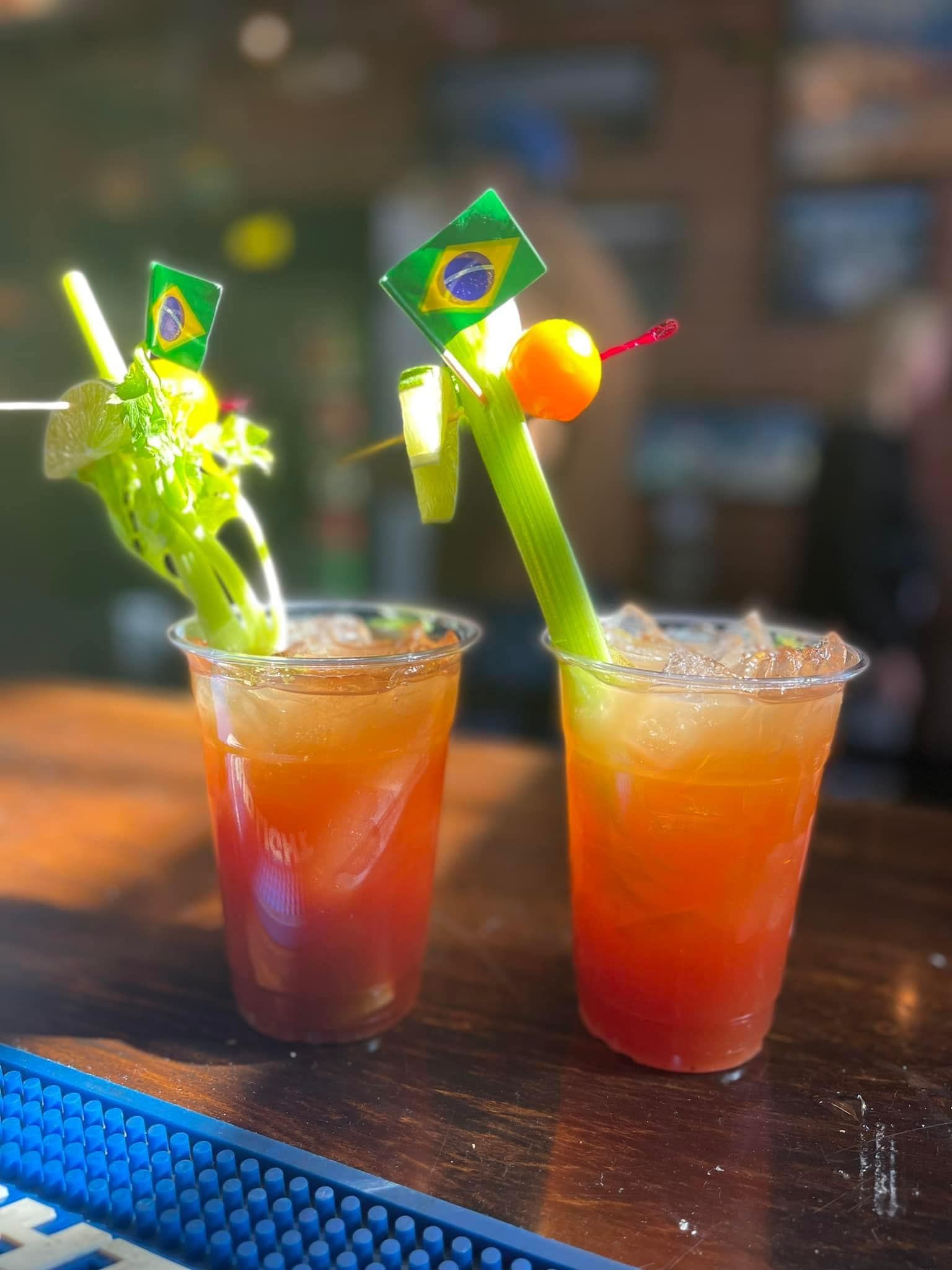 two Bloody Mary's side by side with celery stalks sticking out
