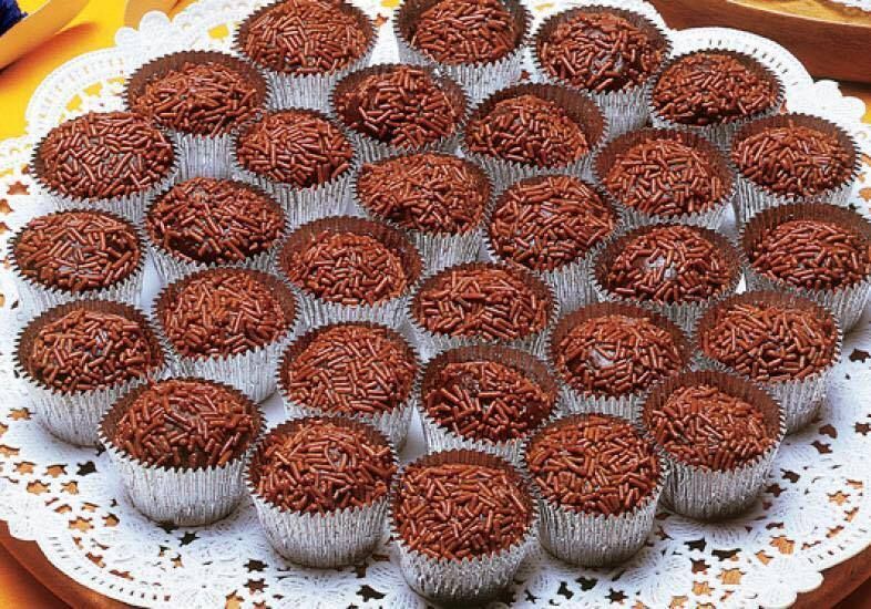 A tray of chocolate cupcakes with sprinkles on top