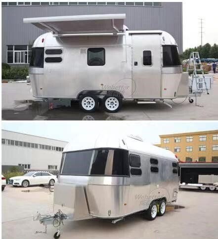 Two silver travel trailers; one with an awning open, the other closed, in an outdoor setting.