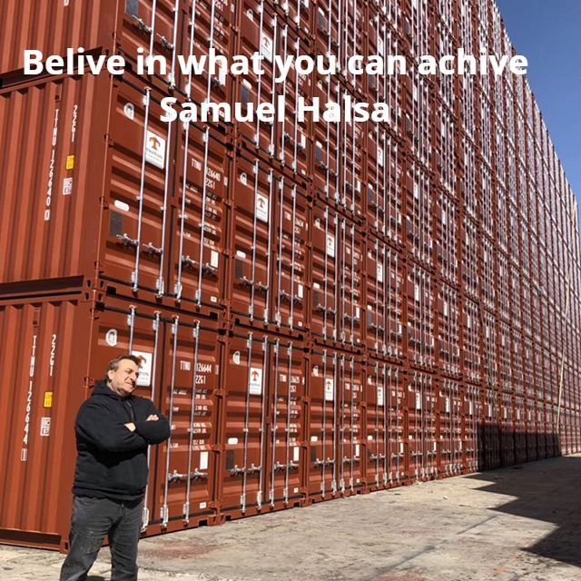 Man standing in front of stacked brown shipping containers. Text: 