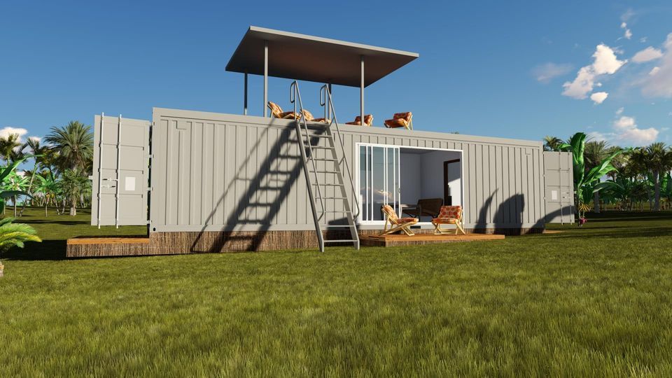 Shipping container home with a rooftop deck and ladder on a grassy field under a blue sky.