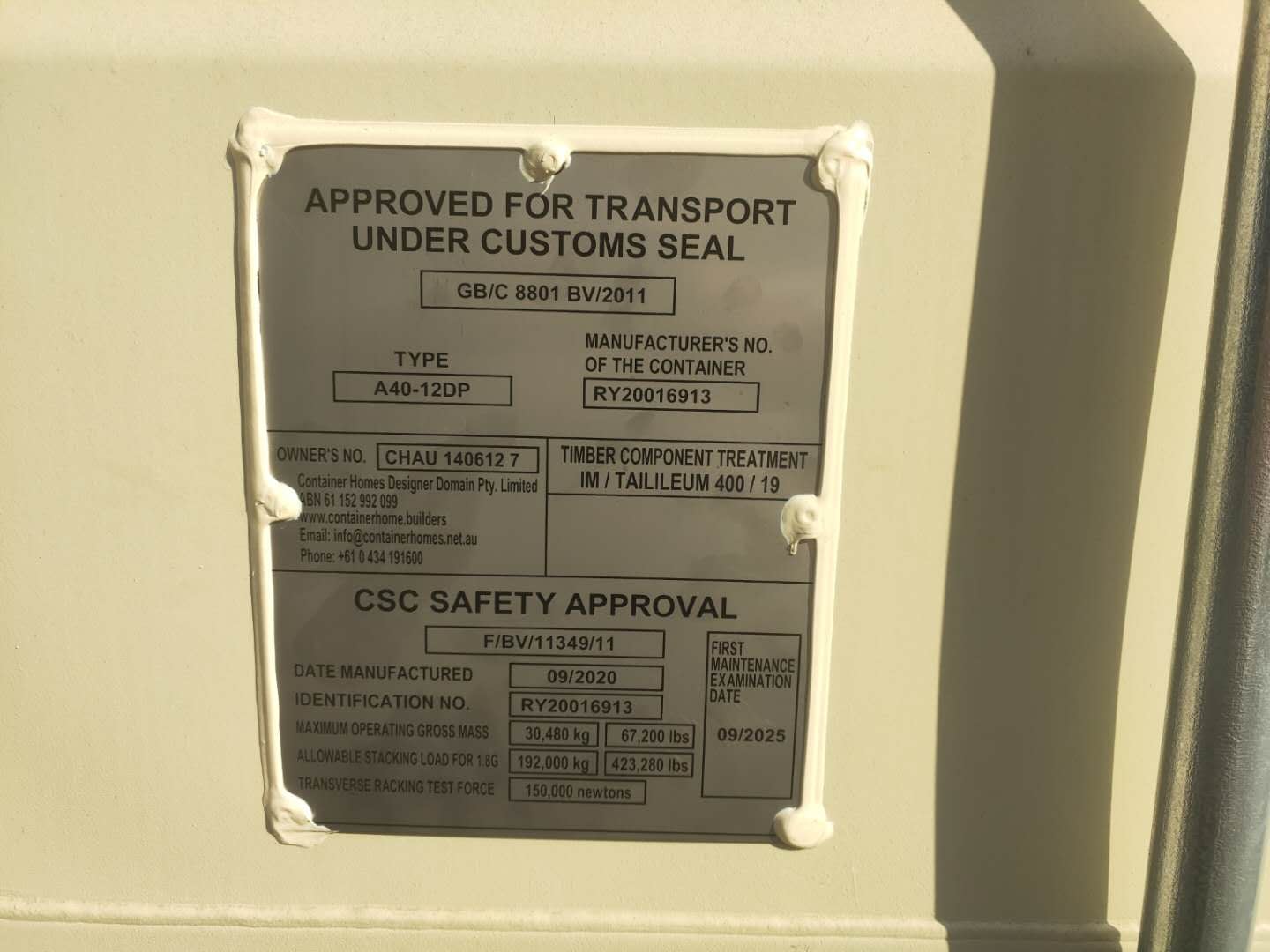 Metal plate on a container, labeled 