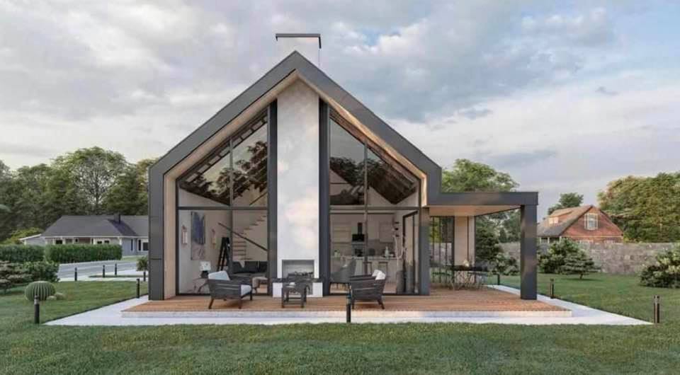 Modern house with large windows and a covered patio on a green lawn.