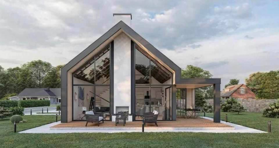 Modern home exterior with large glass windows and an outdoor seating area.
