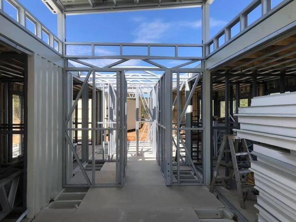 Steel frame construction of a building interior, with doorways and exposed structural elements.