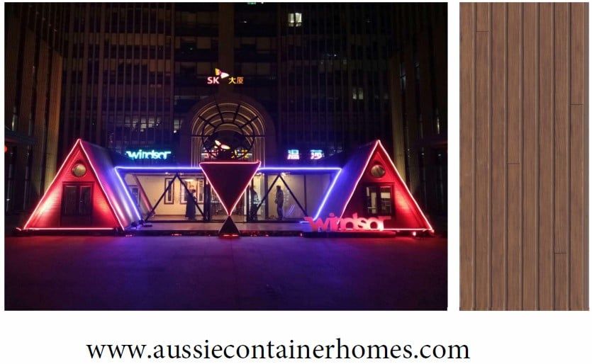 Lit-up A-frame structures at night with dark wood panel sample.