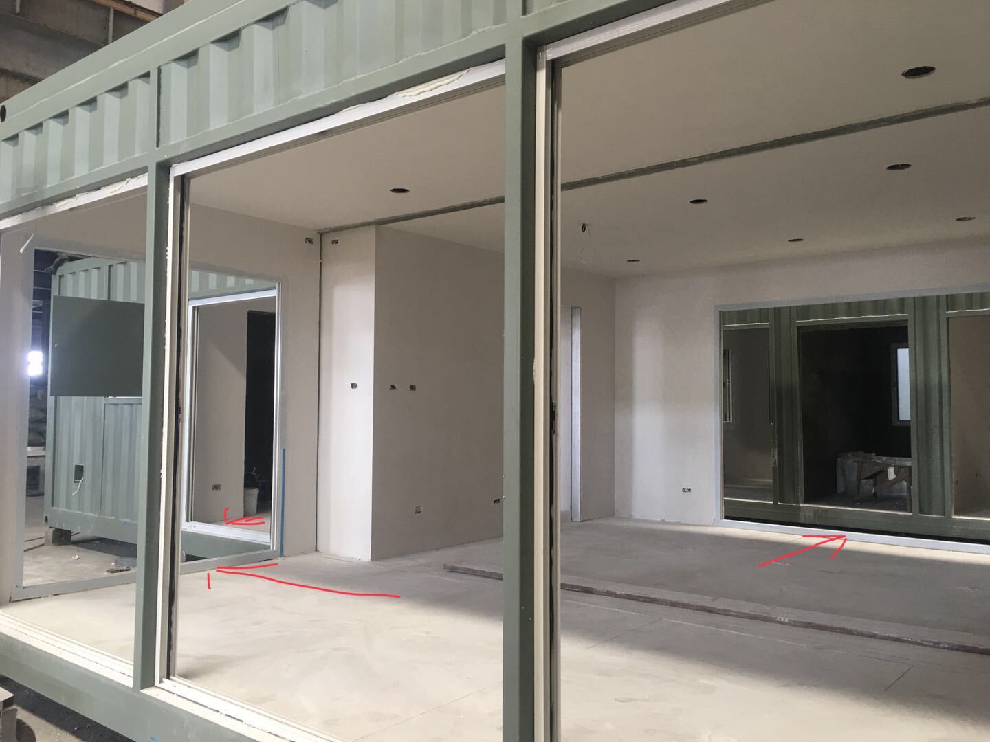 Interior of a modular home under construction, with open doorways and drywall.