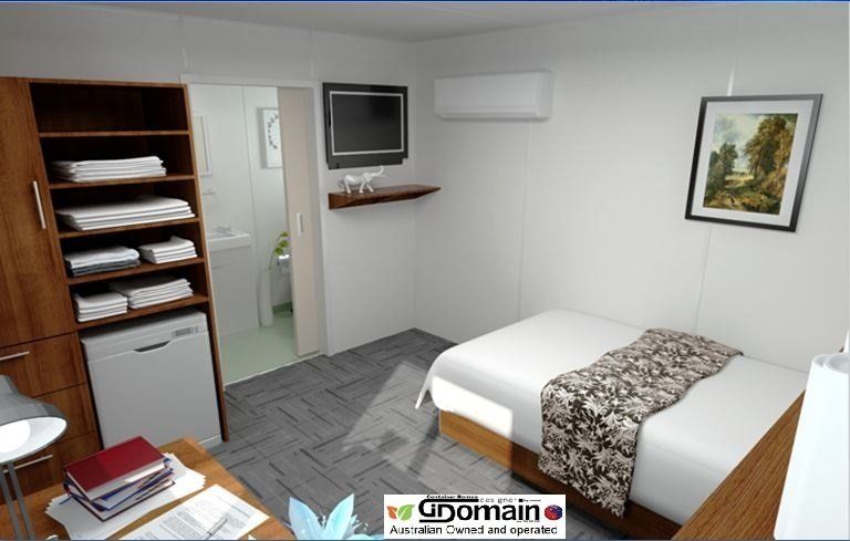 Small furnished bedroom with bed, closet, desk, TV, and a bathroom.