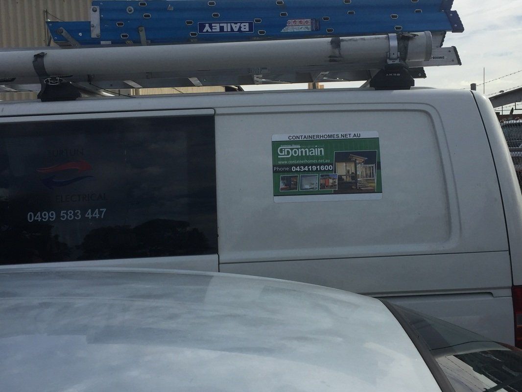 White van with a ladder on top and a company logo on the side.