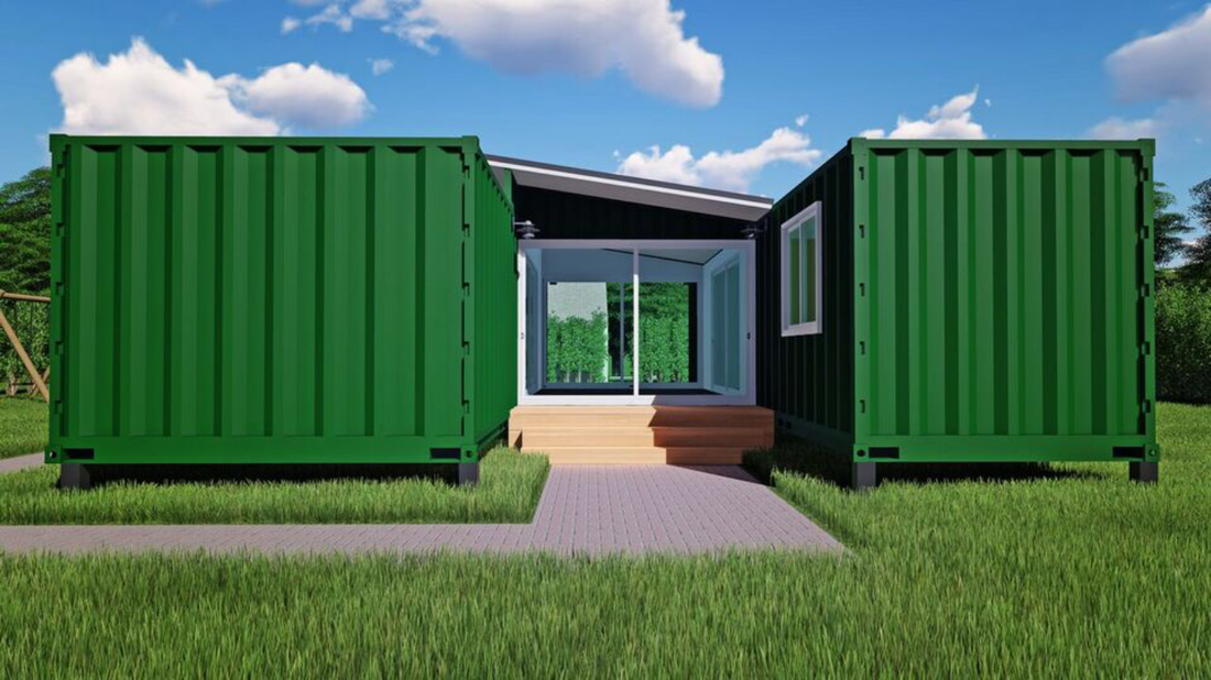 Green shipping container home with steps leading to glass doors, sitting on green grass.