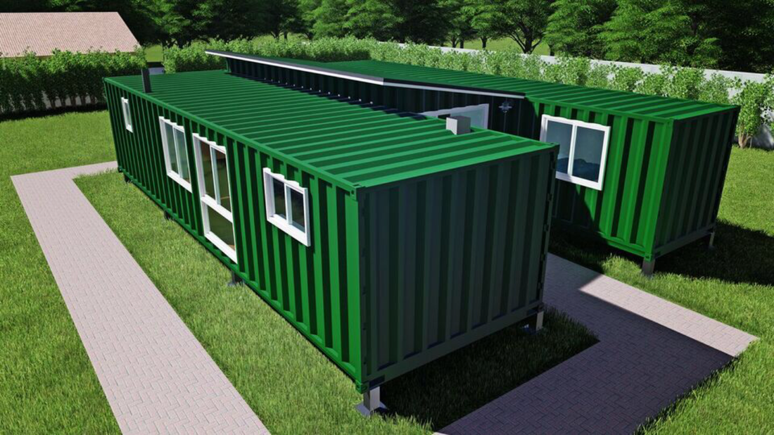 Green shipping container home with white-framed windows, surrounded by green grass and a small pathway.