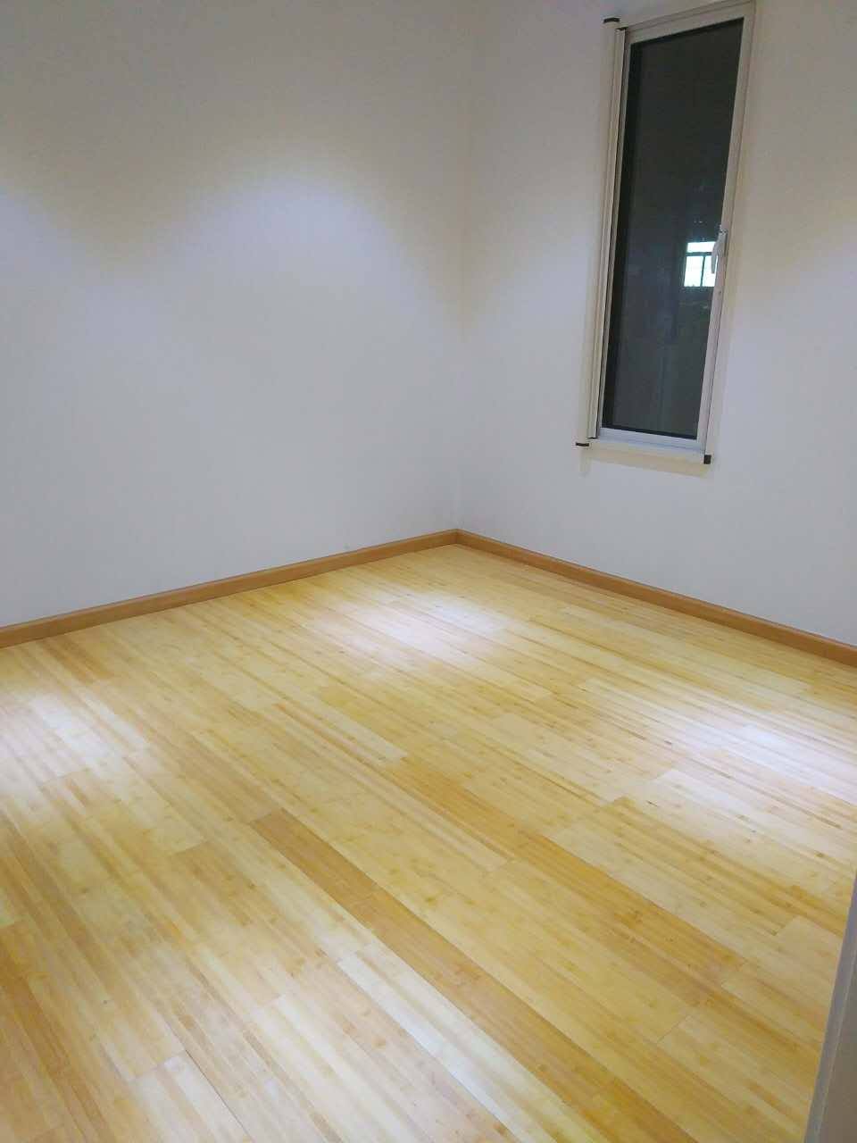Empty room with light wood floor, white walls, and a window.