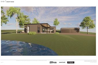 Modern brown house and detached garage on a grassy hill near a body of water with trees, under a blue sky.