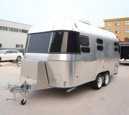 Silver travel trailer parked outdoors.