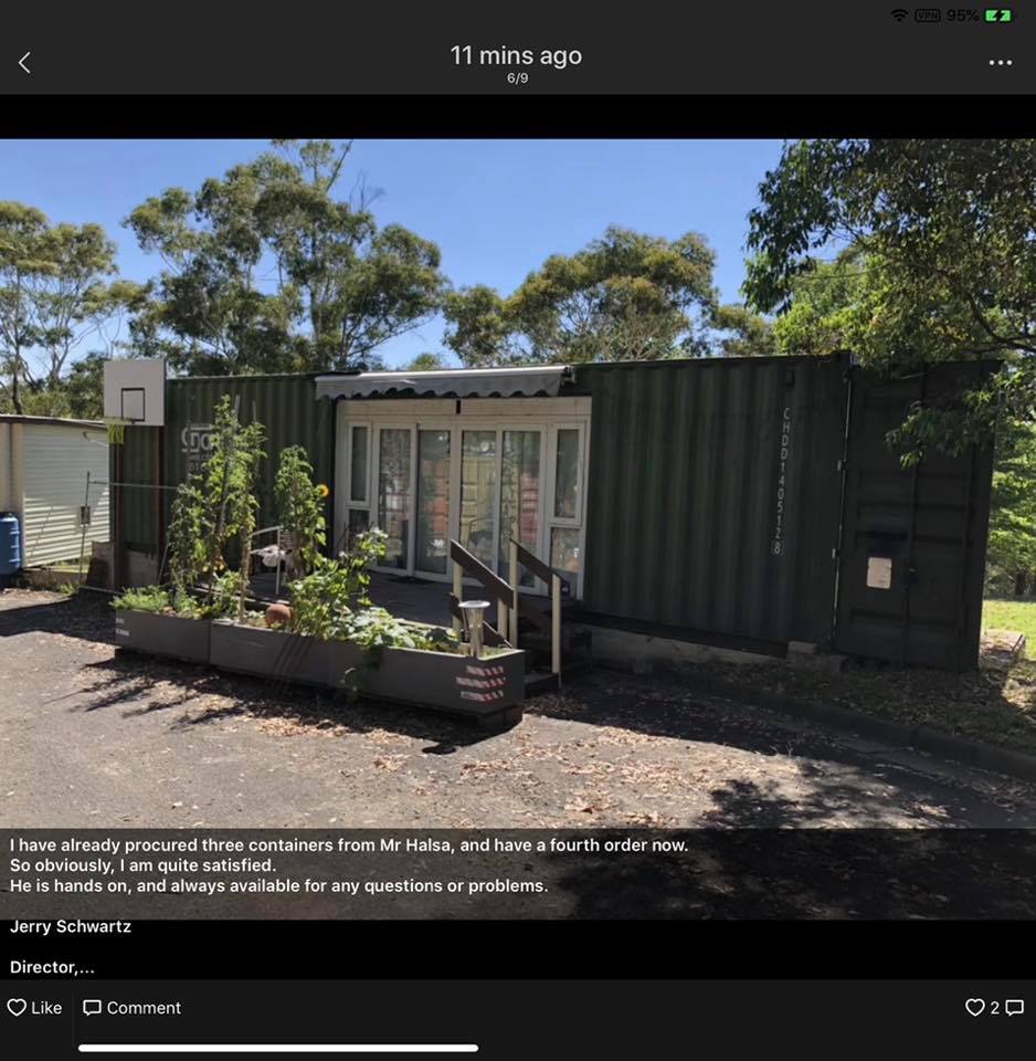 Shipping container home with basketball hoop, plants, and glass doors.