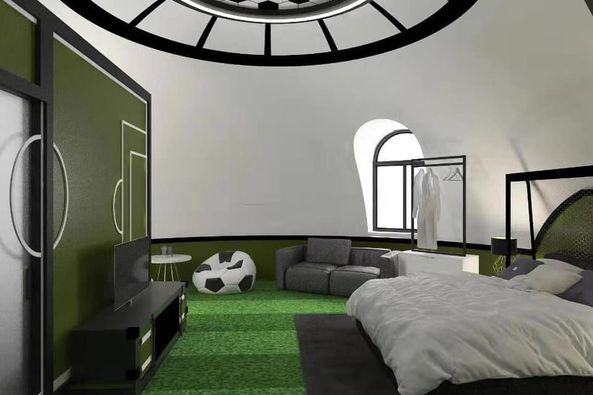 Soccer-themed bedroom with green turf floor, goal-shaped decor, and gray furniture.