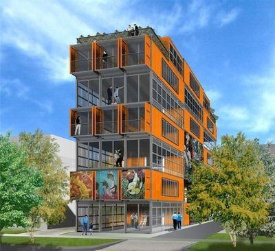 Orange building made of stacked shipping containers; people on balconies, artwork on the ground floor.