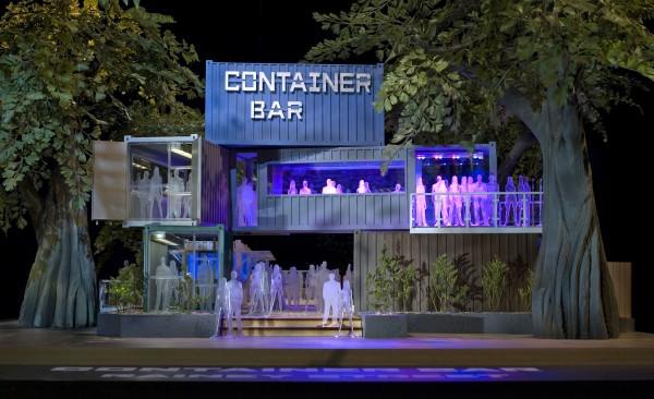 Container Bar: A multi-level bar built from shipping containers, lit with blue and purple lights, and surrounded by trees.
