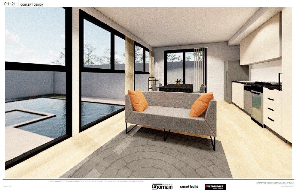 Interior view of a modern living space with large windows overlooking a pool. A gray sofa has orange pillows.