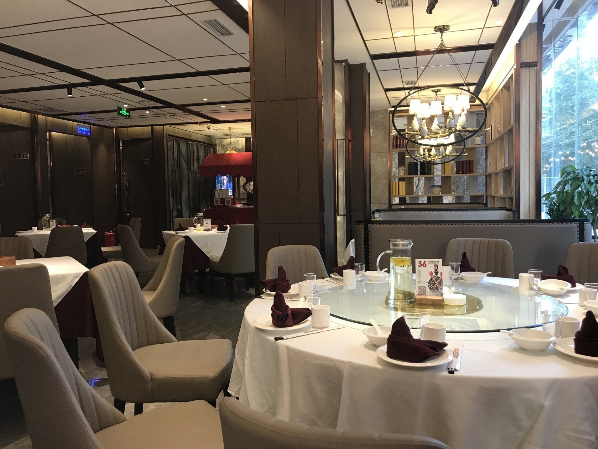Dining room with round tables, chairs, and table settings.