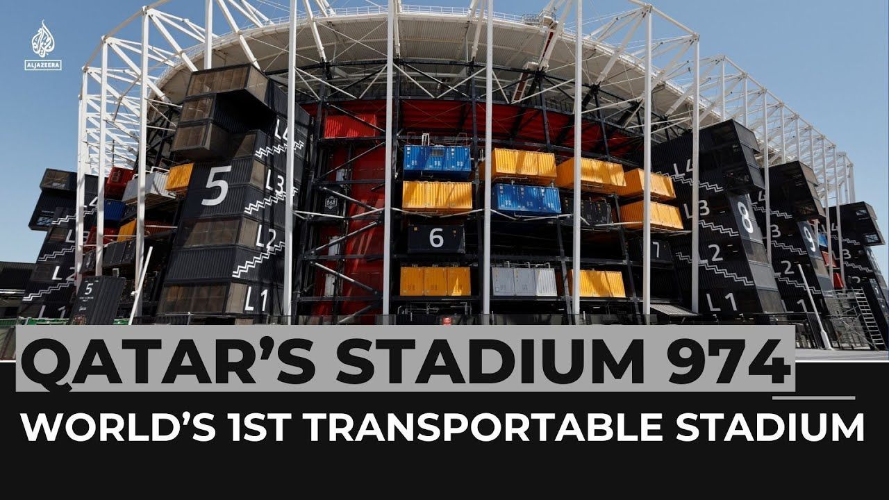 Qatar's Stadium 974, a transportable stadium made of shipping containers. Exterior view, bright sky, numbers on the containers.