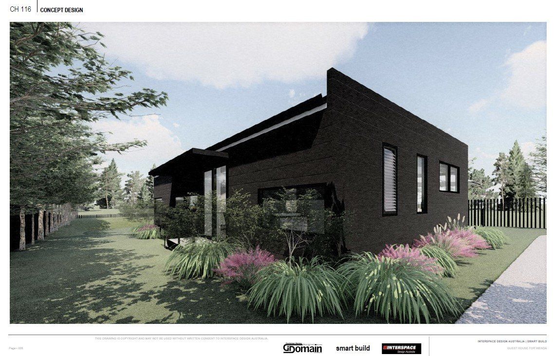Black brick house with angled roof, tall windows, and landscaping.