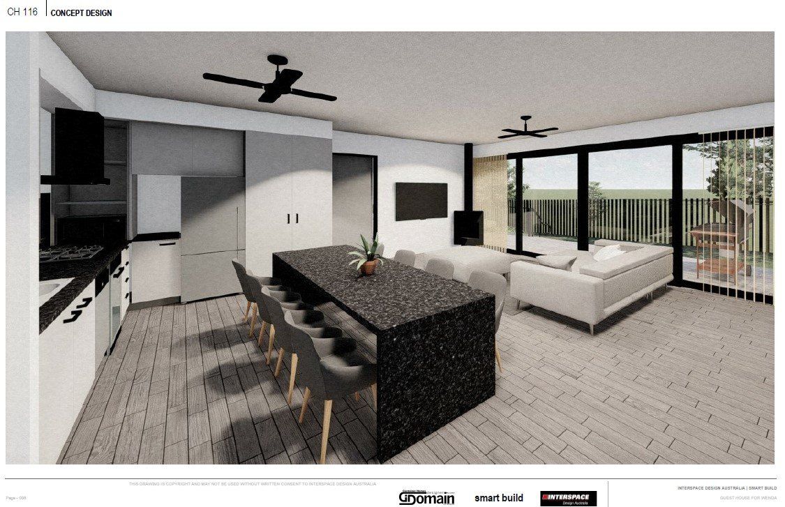 Modern kitchen and living space with island, gray cabinetry, sliding glass doors, and a small sofa.