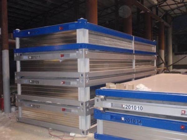 Stacked rectangular industrial containers with blue and silver trim.